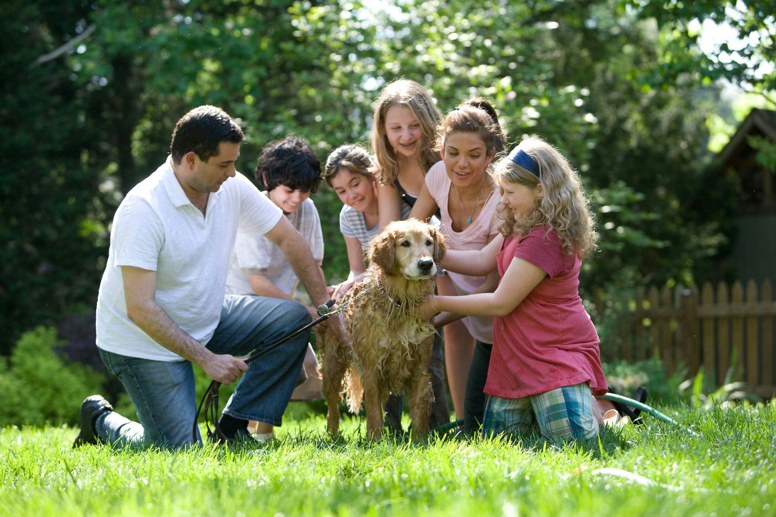 Family gathered with a Golden Retriever outdoors representing active dog-owning households in Marietta