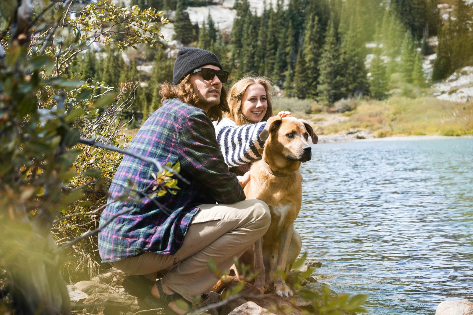 Dog owners with a dog near a lake representing active Acworth households