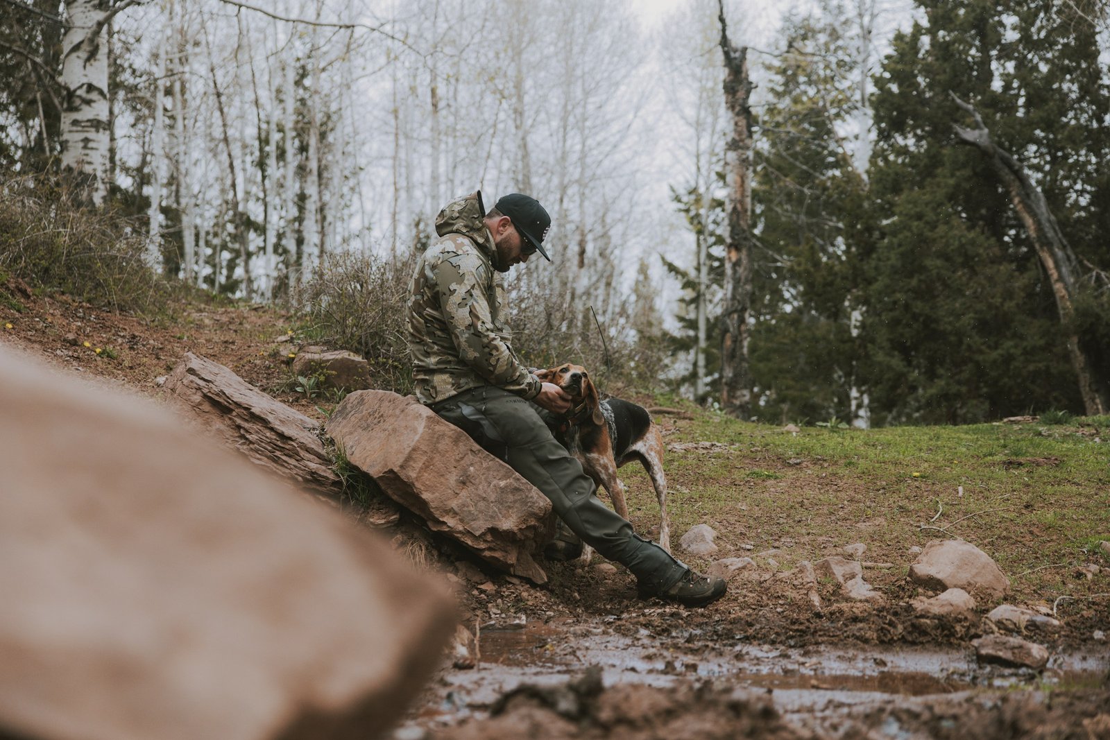 Dog owners with a dog near a lake representing active Milton households