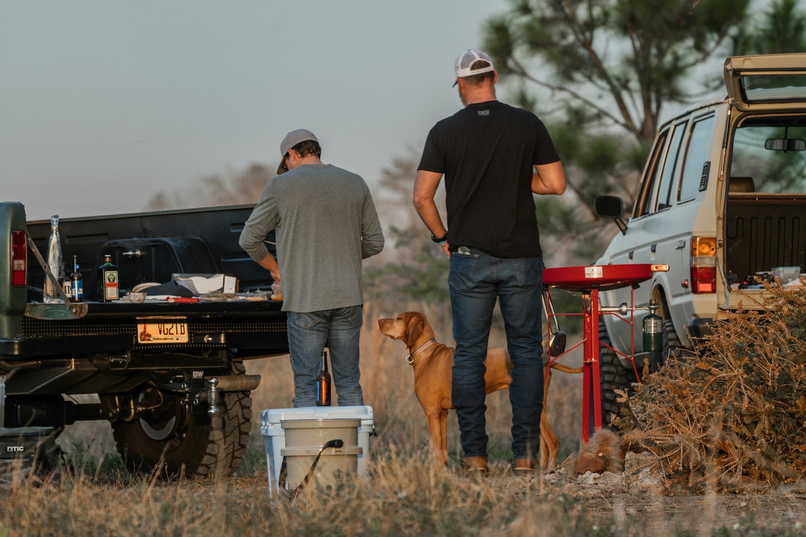 Dog owners with a dog near a lake representing active Woodstock households